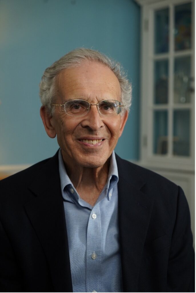 Smiling older man wearing glasses, promoting healthy aging