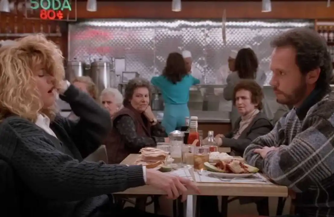 Meg Ryan and Billy Crystal in the iconic "I'll Have What She's Having" scene from When Harry Met Sally.