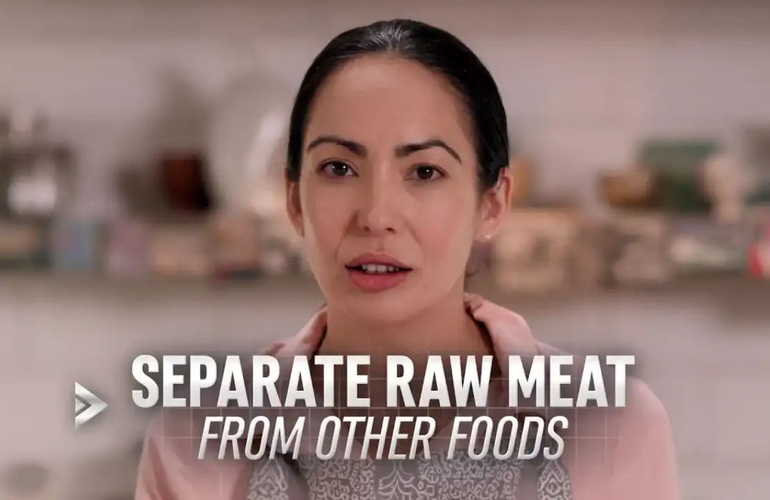 Woman explaining to separate raw meat from other foods to prevent foodborne illness.