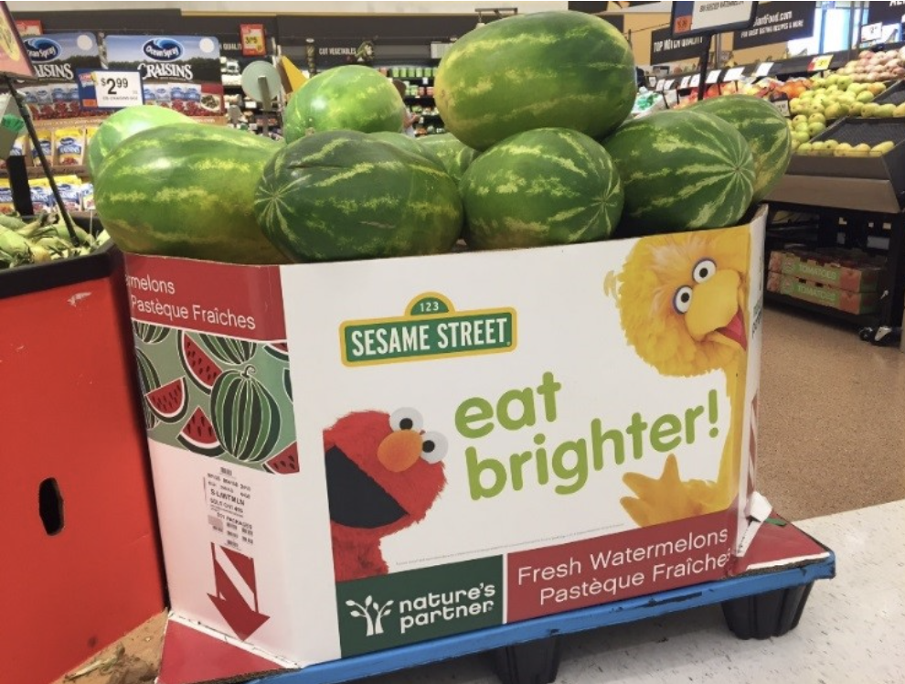 Watermelons in a Sesame Street "eat brighter!" display at a grocery store.