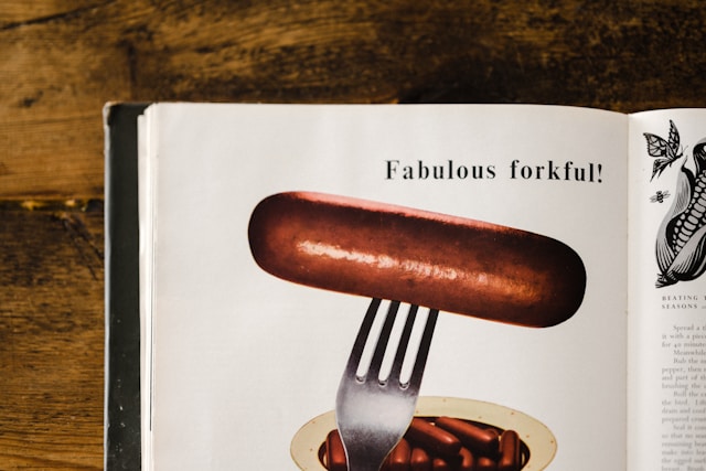 Vintage cookbook page featuring a hot dog on a fork, text: "Fabulous forkful!