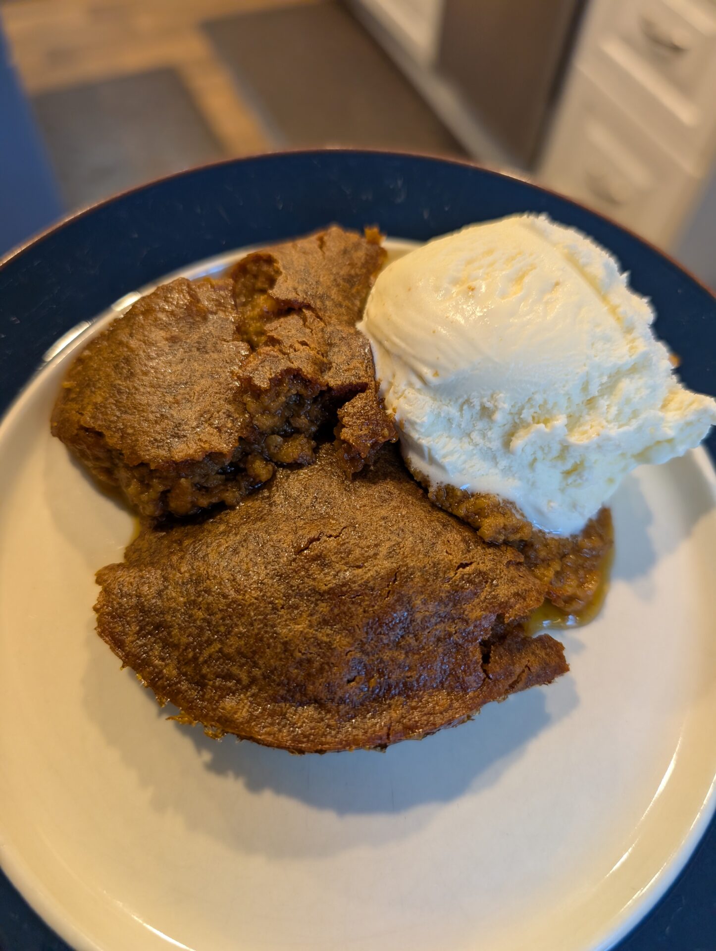 Warm pumpkin pudding with a scoop of vanilla ice cream