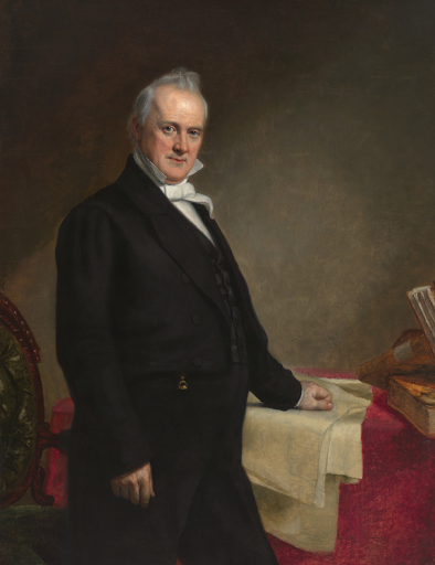 James Buchanan, 15th US President, in formal attire, standing by a table with books.