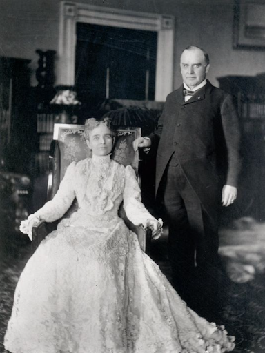 William McKinley and wife Ida in formal attire in a richly decorated room.