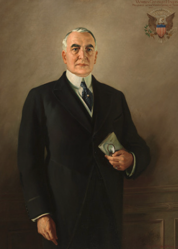 Official portrait of President Warren G. Harding in a suit, holding a book and glasses.