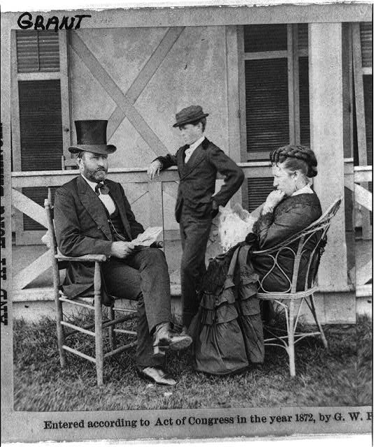 Ulysses S. Grant sits with two others on a porch in 1872.