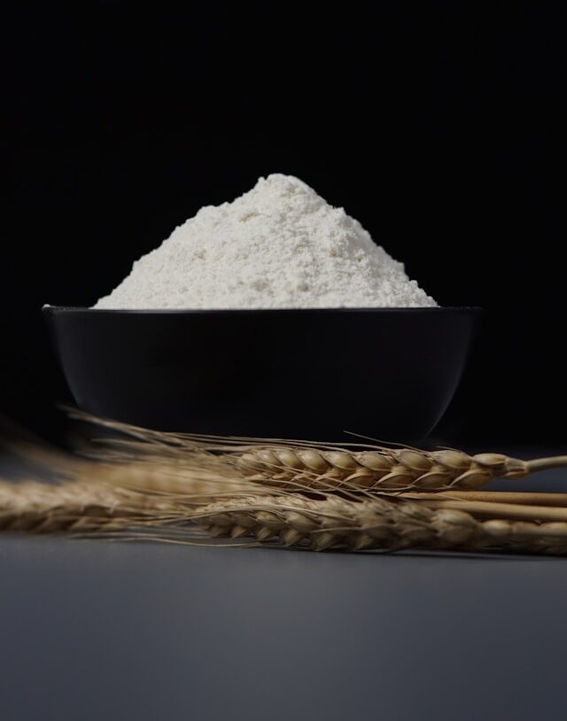 Bowl of white flour with wheat stalks