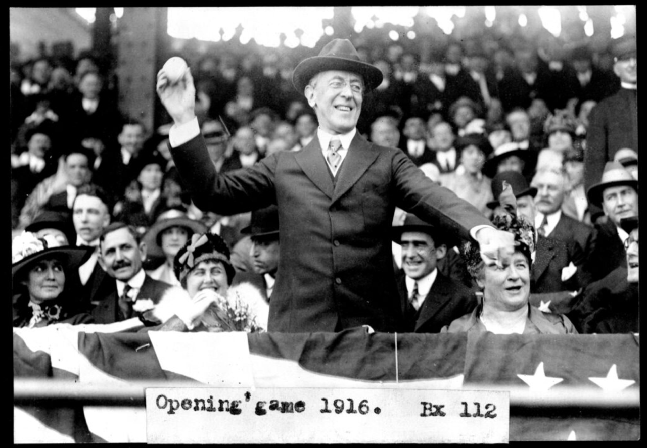 Woodrow Wilson throws the ceremonial first pitch at the 1916 opening game.