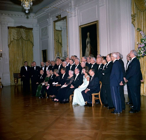 President Kennedy's guests in formal attire at a White House event.