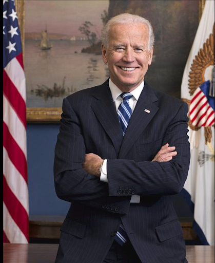 Joe Biden, President of the United States, in a suit with arms crossed.