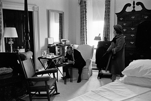 Lyndon B. Johnson eating in a bedroom with Lady Bird Johnson
