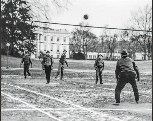 Herbert Hoover playing volleyball outdoors with other men