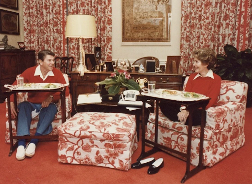 Ronald and Nancy Reagan eating meals on trays in the White House.