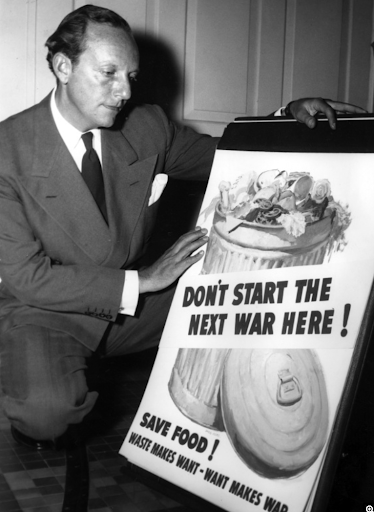Harry S. Truman points to a "Don't Start the Next War Here! Save Food!" poster.